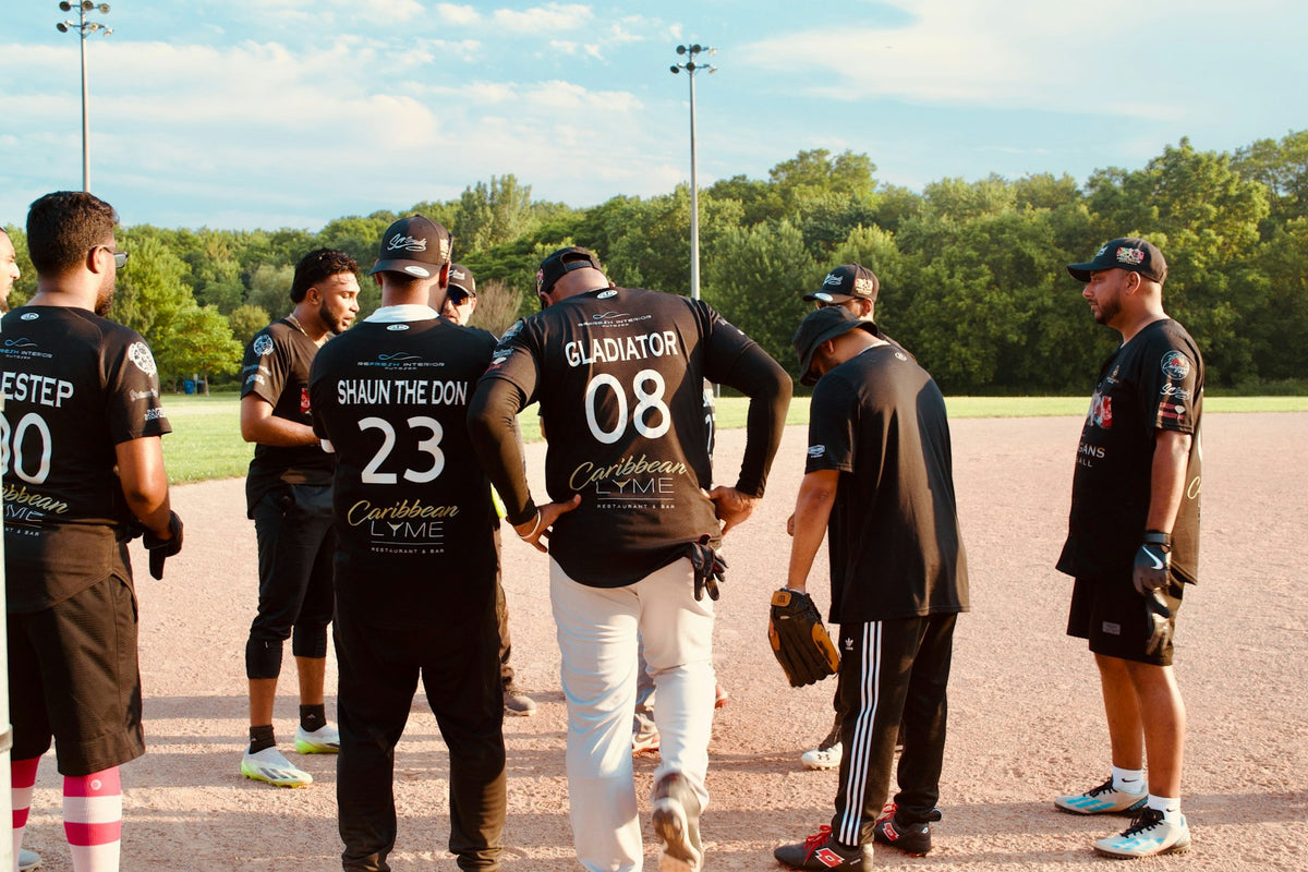Softball teammates in a huddle on the field